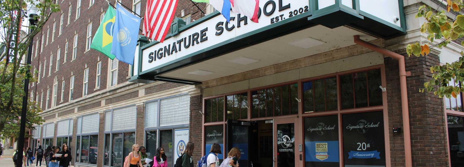 Student walking into building