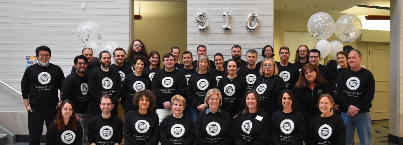 Faculty wearing matching sweatshirts.