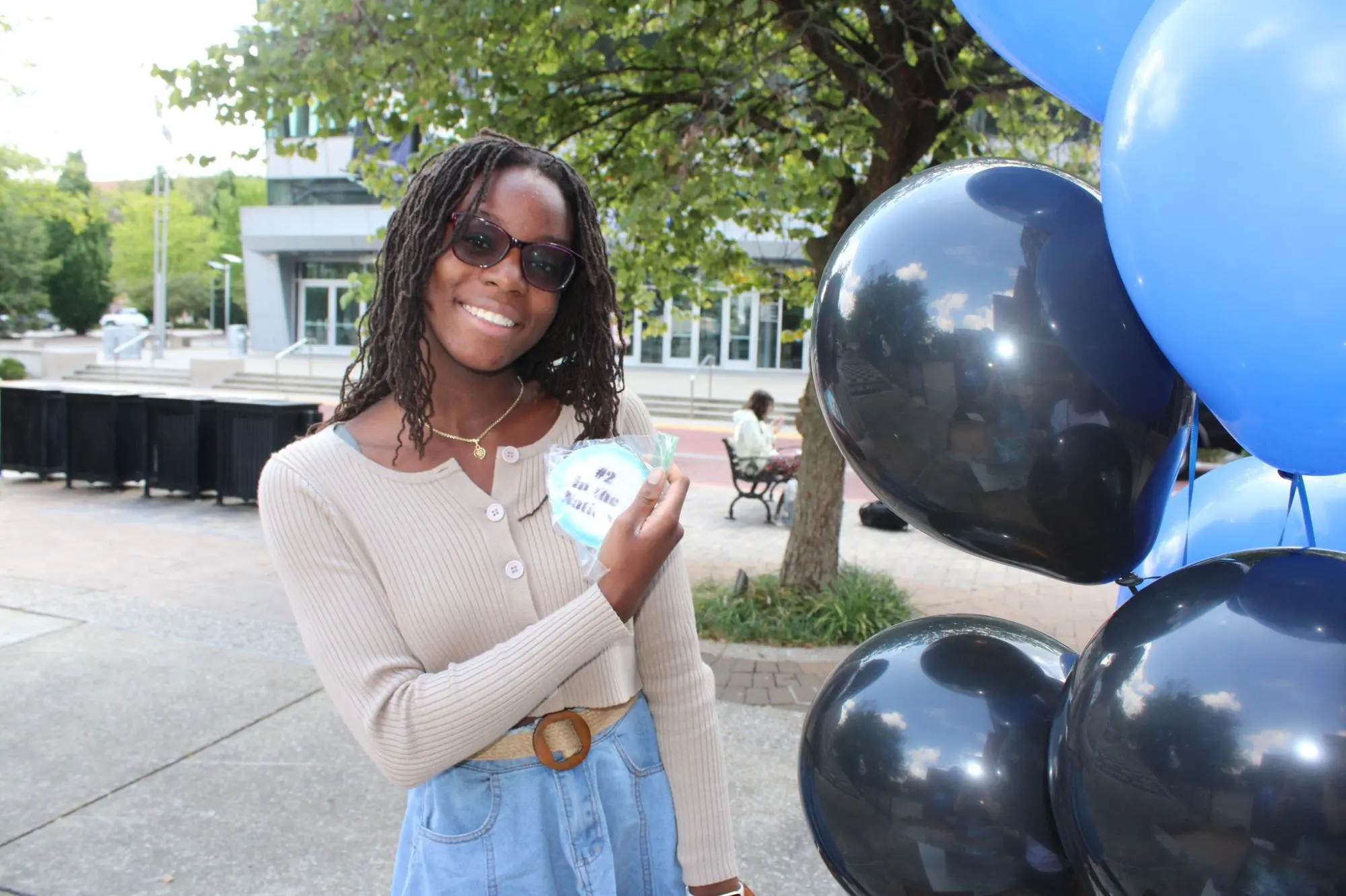 Student with cookie and balloons